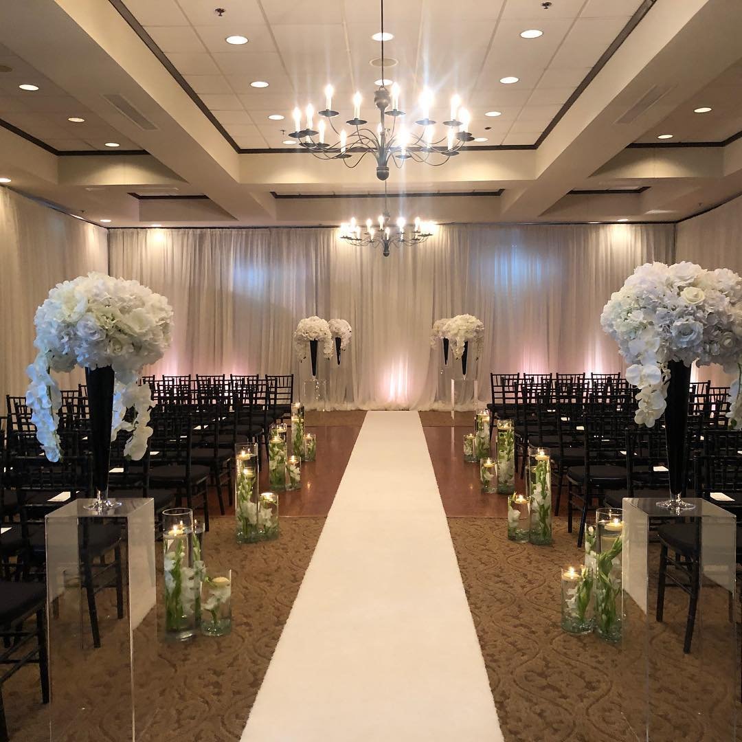 Pipe-and-drape installation framing an event stage