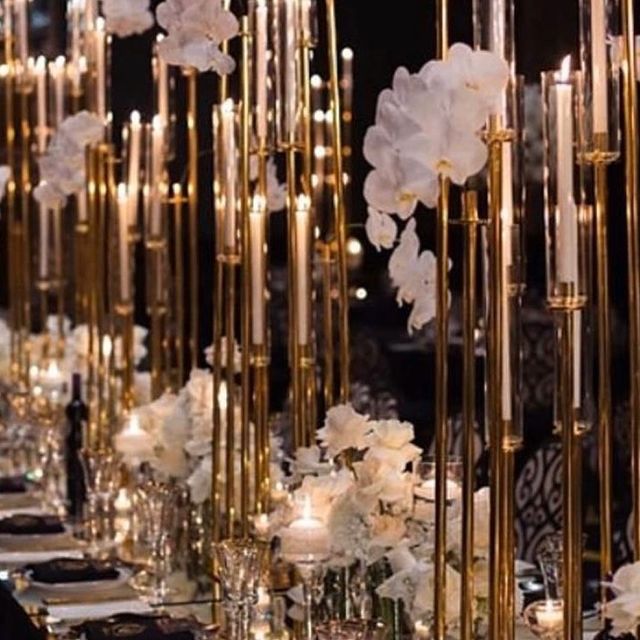 Pillar candles styled across a reception tabletop