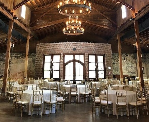 Close view of gold Chiavari chairs at a reception table