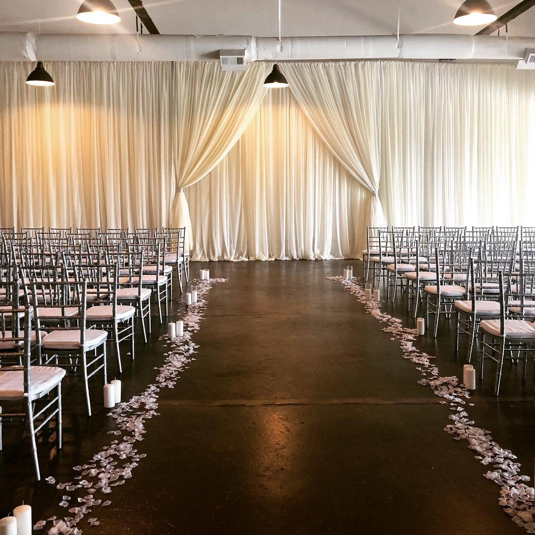 Reception styled with silver Chiavari chairs and draped altar